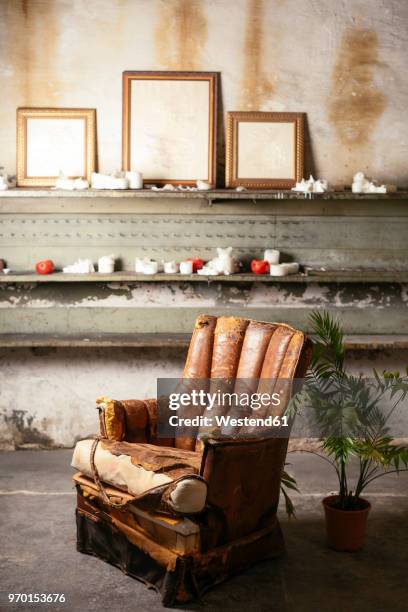 broken leather chair in a loft - broken chair stock pictures, royalty-free photos & images