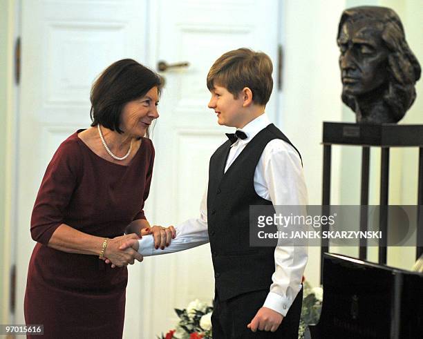 Piotr Pawlak is greeted by Polish First Lady Maria Kaczynska after playing compositions by Frederic Chopin in the Polish presidential palace in...