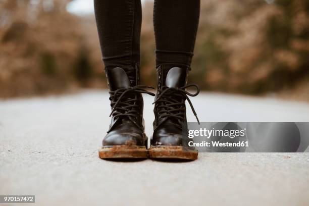 woman wearing black boots, partial view - leather boot stock pictures, royalty-free photos & images