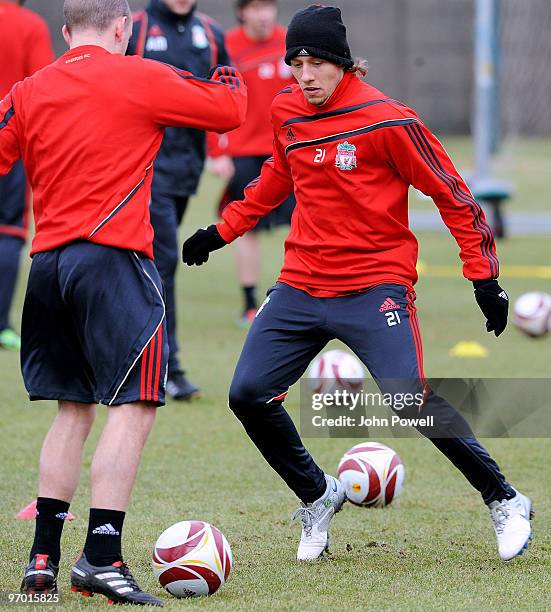 Lucas Leiva of Liverpool challenges team mate Jay Spearing during a training session ahead of their UEFA Europa League Round 32 second leg match...