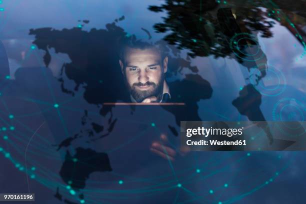 businessman with tablet in car at night surrounded by data - travel experience stock-fotos und bilder