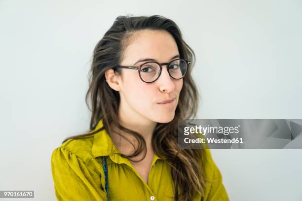 portrait of young woman wearing glasses - suspicion stock pictures, royalty-free photos & images