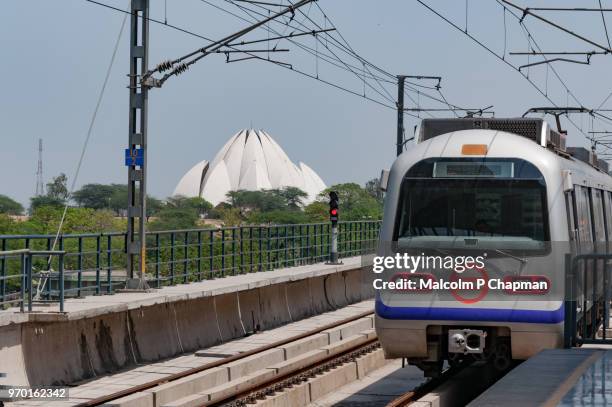 delhi metro and bahai (bahá'í) house of worship, lotus temple, new delhi, india - delhi metro train stock pictures, royalty-free photos & images