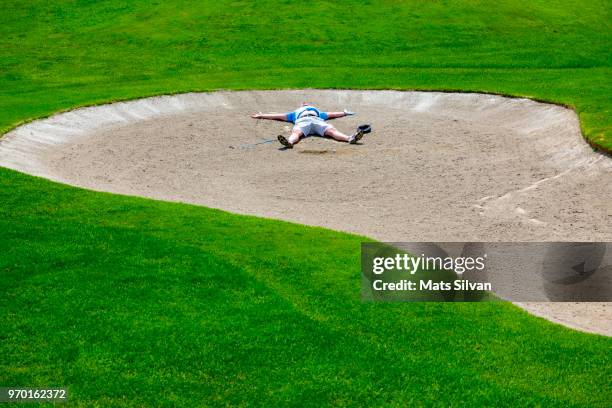 desperate golfer lying in a bunker - defeat funny stock pictures, royalty-free photos & images