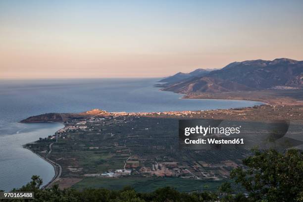 greece, peloponnese, arcadia, paralia astros, view to paralia astros and fertile plain of astros in the evening - arcadia greece stock pictures, royalty-free photos & images