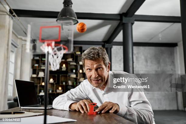 portrait of mature business man playing office games in loft - 1 minute 50 stock pictures, royalty-free photos & images