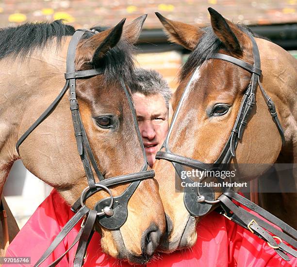 Trainer Paul Nicholls with his Queen Mother Champion Chase horses Twist Magic and Master Minded during an open day at his Manor farm Stables on...