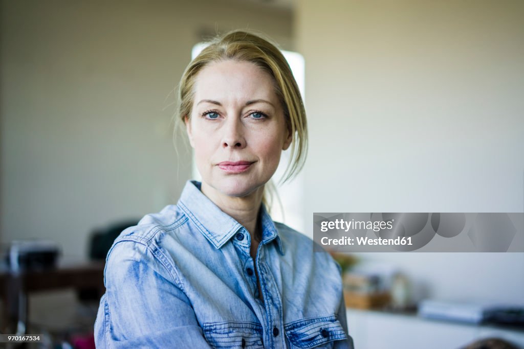 Portrait of blond businesswoman wearing denim shirt