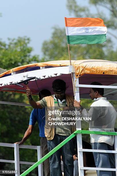 An Indian wildlife worker checks the signal of a radio collar placed on a tigress just released into Storekhali forest in the Sundarbans, some 130 km...