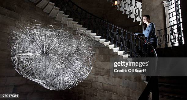 Woman admires an artwork entitled �Flare II� by sculptor Antony Gormley, installed in St Paul's Cathedral�s Geometric Staircase on February 24, 2010...