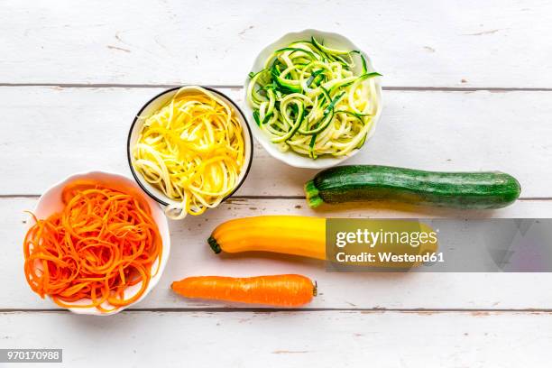 zoodles, green and yellow zucchini, carrot on white wood - low carb diet stock pictures, royalty-free photos & images