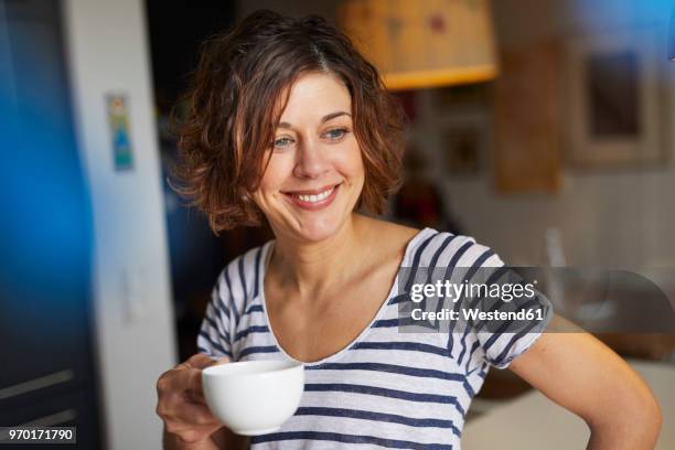 portrait of relaxed mature woman with cup of coffee at home - 40 2018 stock pictures, royalty-free photos & images