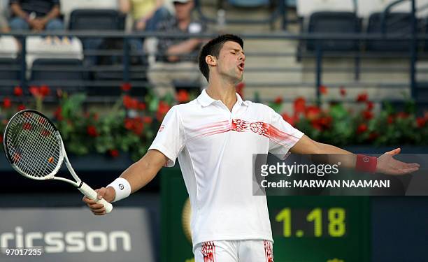 Serbia's Novak Djokovic gestures after losing a point to his compatriot Viktor Troicki during their match in the second round of the ATP Dubai Open...