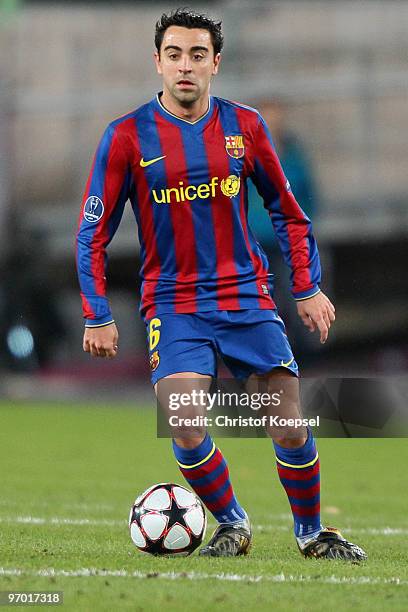 Xavi of Barcelona runs with the ball during the UEFA Champions League round of sixteen, first leg match between VfB Stuttgart and FC Barcelona at...