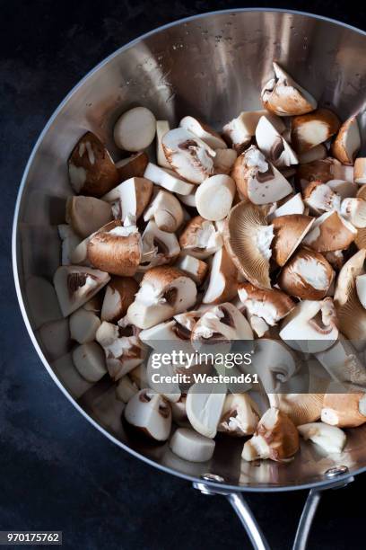 sliced crimini mushrooms in stainless steel pan - crimini mushroom stock pictures, royalty-free photos & images