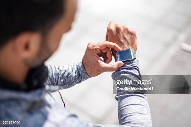 close-up of athlete checking smartwatch - checking sports stock pictures, royalty-free photos & images