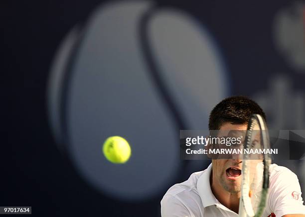 Serbia's Novak Djokovic returns to his compatriot Viktor Troicki during their match in the second round of the ATP Dubai Open tennis championship in...