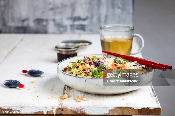 salad with glas noodles, cabbage, carrots, bell peppers, spring onions, peanuts and hot thai dressing - soy dressing stock pictures, royalty-free photos & images