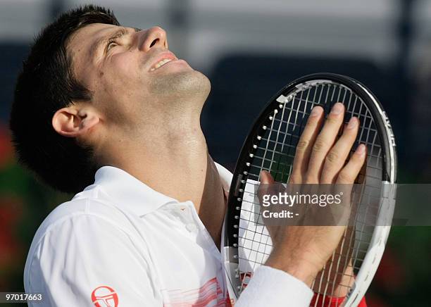 Serbia's Novak Djokovic reacts after losing a point to his compatriot Viktor Troicki during their match in the second round of the ATP Dubai Open...