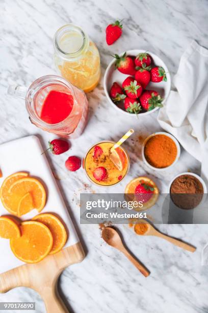 strawberry and orange smoothie with curcuma and cinnamon on marble - curcuma stock pictures, royalty-free photos & images