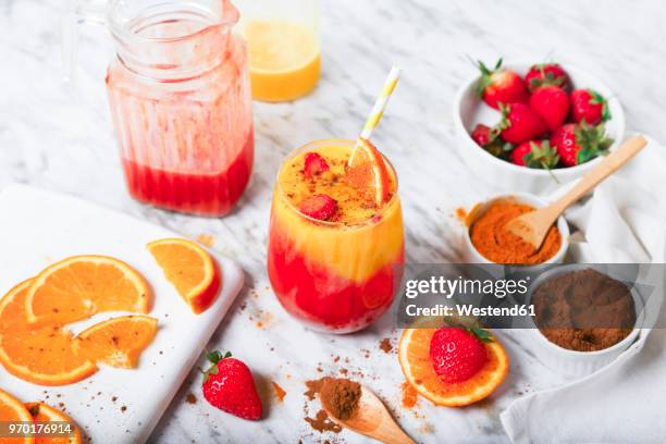 strawberry and orange smoothie with curcuma and cinnamon on marble - curcuma stock pictures, royalty-free photos & images