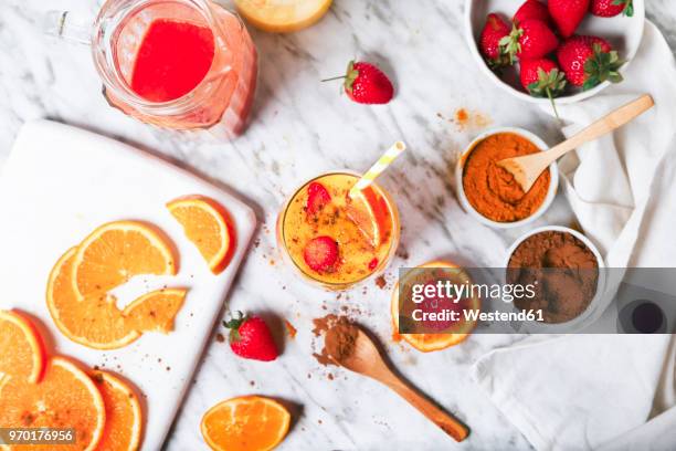 strawberry and orange smoothie with curcuma and cinnamon on marble - curcuma stock pictures, royalty-free photos & images