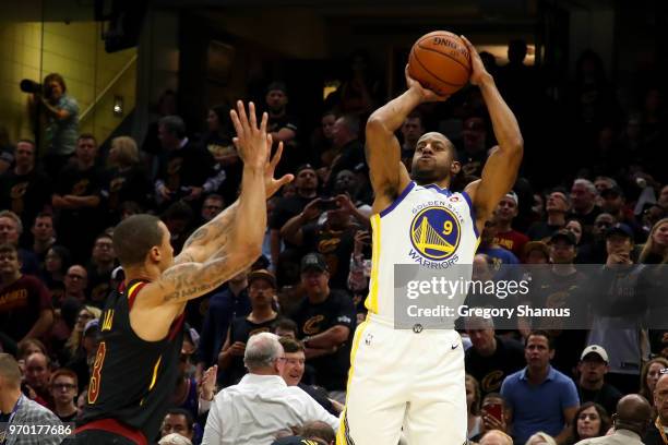Andre Iguodala of the Golden State Warriors shoots over George Hill of the Cleveland Cavaliers in the first half during Game Four of the 2018 NBA...