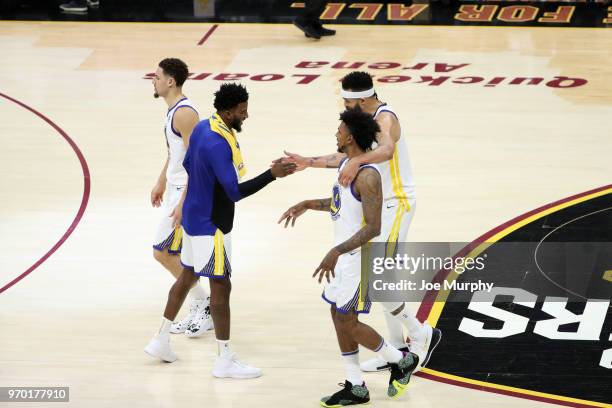 Jordan Bell high fives Nick Young and JaVale McGee of the Golden State Warriors in Game Four of the 2018 NBA Finals on June 8, 2018 at Quicken Loans...