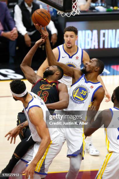 Kevin Durant of the Golden State Warriors and Tristan Thompson of the Cleveland Cavaliers compete for the ball in the first half during Game Four of...