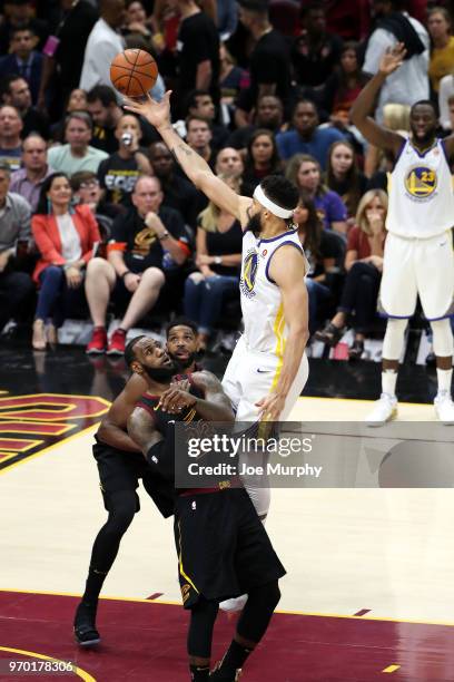 JaVale McGee of the Golden State Warriors goes to the basket over Tristan Thompson and LeBron James of the Cleveland Cavaliers in Game Four of the...