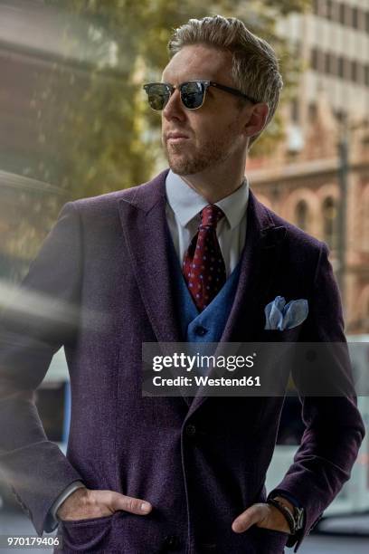 portrait of fashion blogger steve wearing sunglasses and suit - purple suit stock pictures, royalty-free photos & images