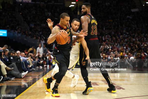 George Hill of the Cleveland Cavaliers handles the ball against Stephen Curry of the Golden State Warriors in the second half during Game Four of the...