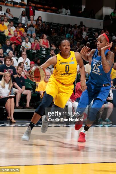 Kelsey Mitchell of the Indiana Fever handles the ball against Glory Johnson of the Dallas Wings on June 8, 2018 at Bankers Life Fieldhouse in...