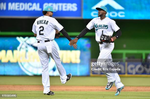 Yadiel Rivera of the Miami Marlins celebrates with Cameron Maybin after defeating the San Diego Padres at Marlins Park on June 8, 2018 in Miami,...