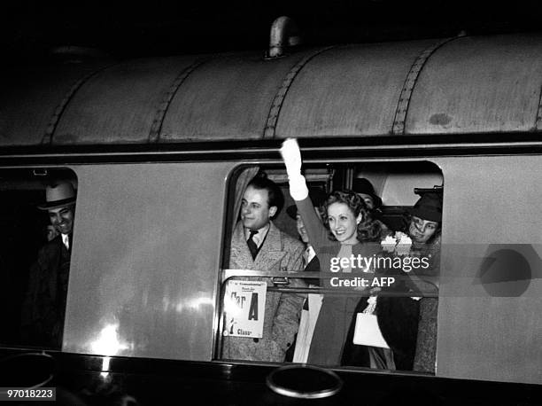 French actress Danielle Darrieux waves to fans at her return from Hollywood in 1938 at Saint-Lazare station in Paris.