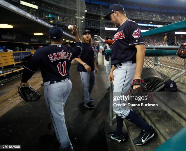Starting pitcher Trevor Bauer of the Cleveland Indians, right, returns to the dugout with Jose Ramirez of the Cleveland Indians after pitching the...