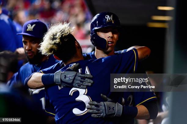 Christian Yelich of the Milwaukee Brewers is hugged by teammate Orlando Arcia after Yelich homered in the eighth inning against the Philadelphia...