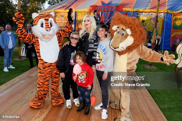 Zuma Rossdale, Apollo Bowie Rossdale, Gewn Stefani and Kingston Rossdale pose with costumed performers during the Moschino Spring/Summer 19 Menswear...