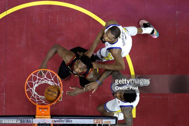 Jeff Green of the Cleveland Cavaliers watches a shot against Kevin Durant and Jordan Bell of the Golden State Warriors in the first half during Game...