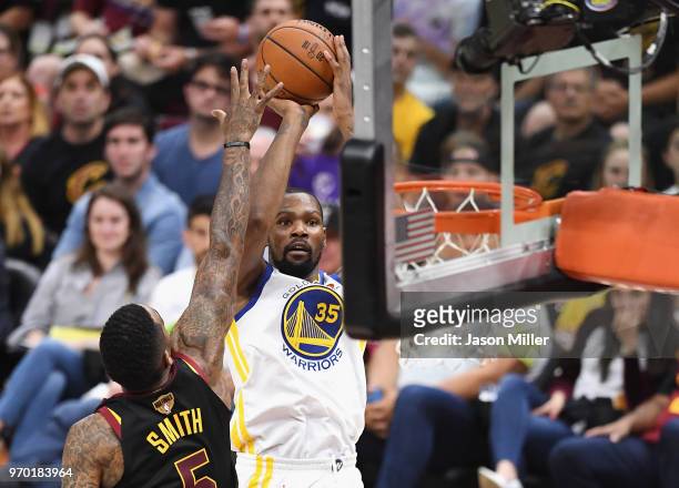 Kevin Durant of the Golden State Warriors shoots against JR Smith of the Cleveland Cavaliers in the second half during Game Four of the 2018 NBA...