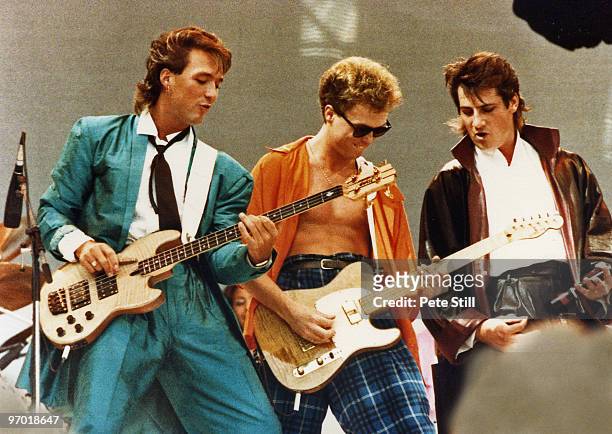 Martin Kemp, Gary Kemp and Tony Hadley of Spandau Ballet perform on stage at Live Aid, Wembley Stadium, on July 13th, 1985 in London, England.