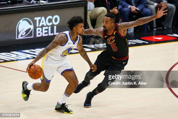 Nick Young of the Golden State Warriors dribbles with the ball defended by JR Smith of the Cleveland Cavaliers during Game Four of the 2018 NBA...