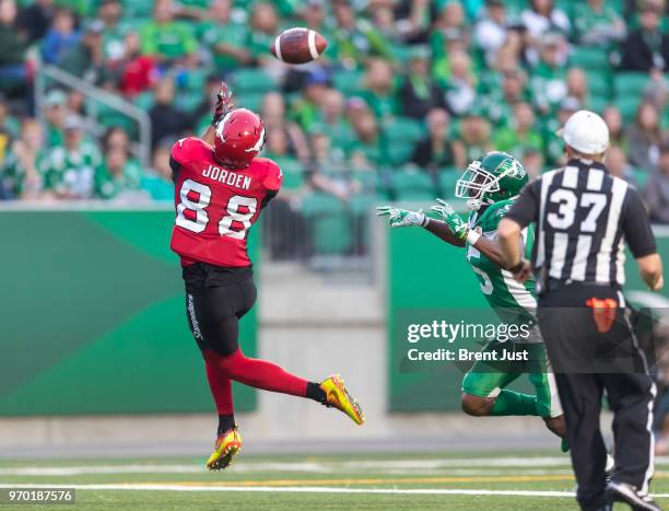 Kamar Jorden of the Calgary Stampeders hauls in a touchdown catch behind Crezdon Butler of the Saskatchewan Roughriders in the first half of the...