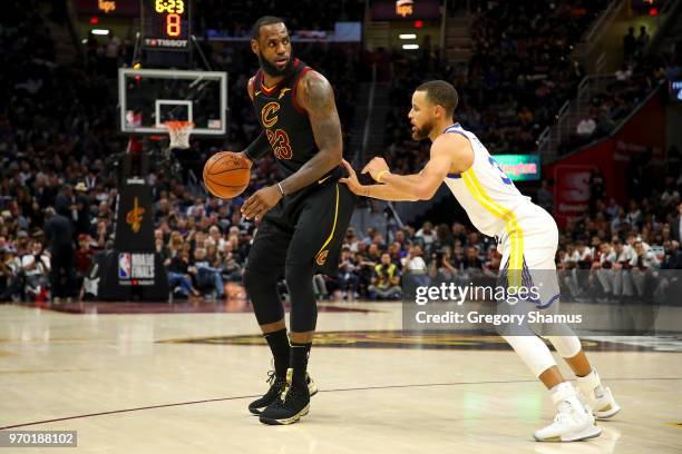 LeBron James of the Cleveland Cavaliers drives to the basket defended by Stephen Curry of the Golden State Warriors during Game Four of the 2018 NBA...