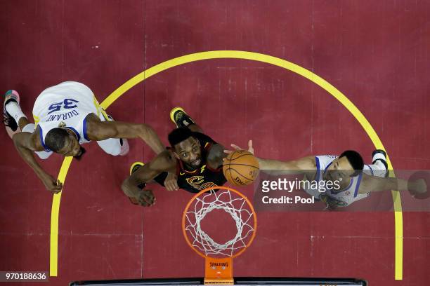Jeff Green of the Cleveland Cavaliers and Shaun Livingston and Kevin Durant of the Golden State Warriors fight for a rebound during Game Four of the...