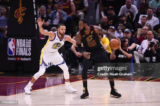 LeBron James of the Cleveland Cavaliers handles the ball against Stephen Curry of the Golden State Warriors during Game Four of the 2018 NBA Finals...