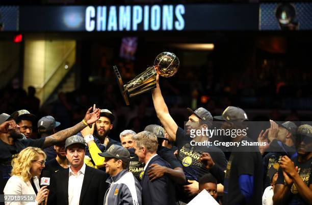 Zaza Pachulia of the Golden State Warriors celebrates with the Larry O'Brien Trophy after defeating the Cleveland Cavaliers during Game Four of the...