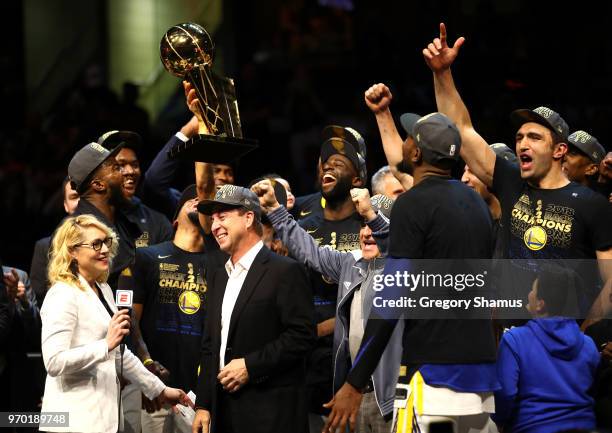 The Golden State Warriors celebrate with the Larry O'Brien Trophy after defeating the Cleveland Cavaliers during Game Four of the 2018 NBA Finals at...