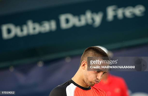 Serbia's Viktor Troicki gestures after loosing a point to his compatriot Novak Djokovic during their match in the second round of the ATP Dubai Open...