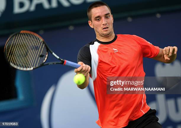 Serbia's Viktor Troicki returns to his compatriot Novak Djokovic during their match in the second round of the ATP Dubai Open tennis championship in...
